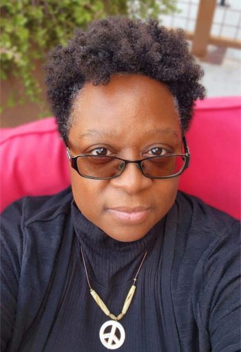 Photo of author M. H. Mundy Photo of author M. H. Mundy wearing a black turtleneck against a pink background.